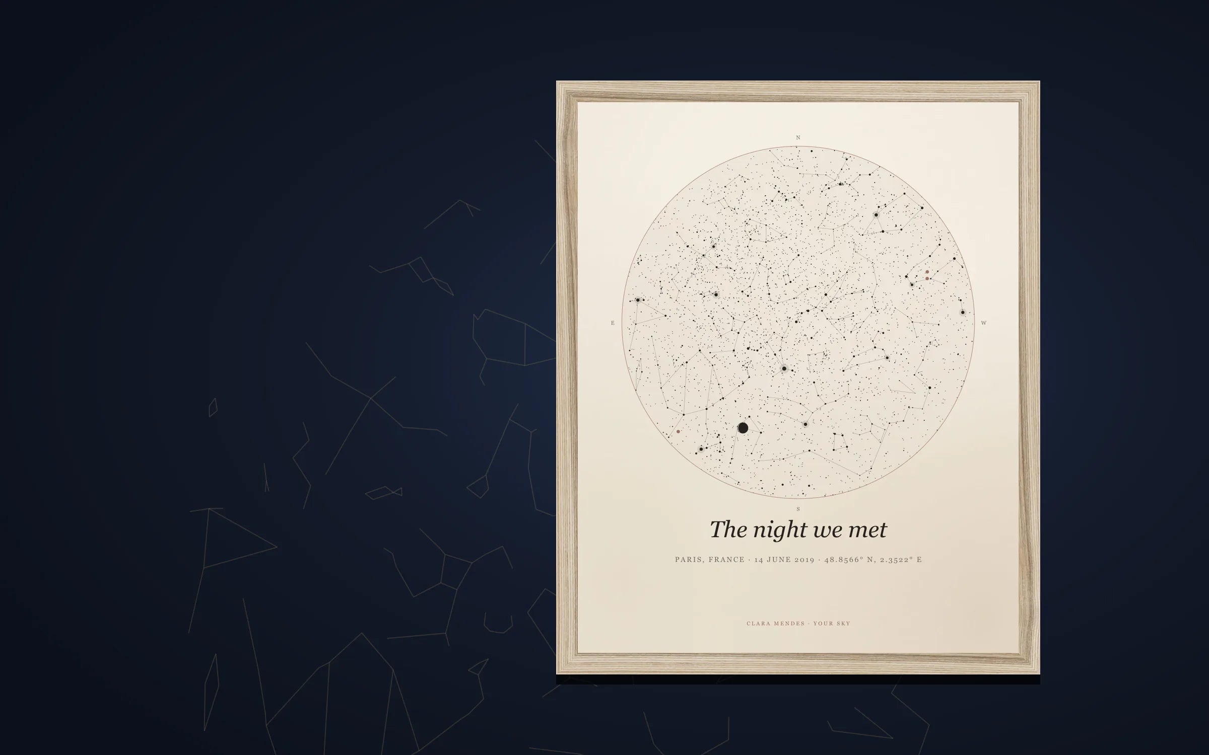 A framed Your Sky star map print — the linen edition in a natural frame on a dark wall